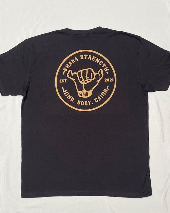 Back of the black Shaka Strength t-shirt with the large gold logo